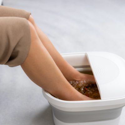 Woman do foot bath herself at home